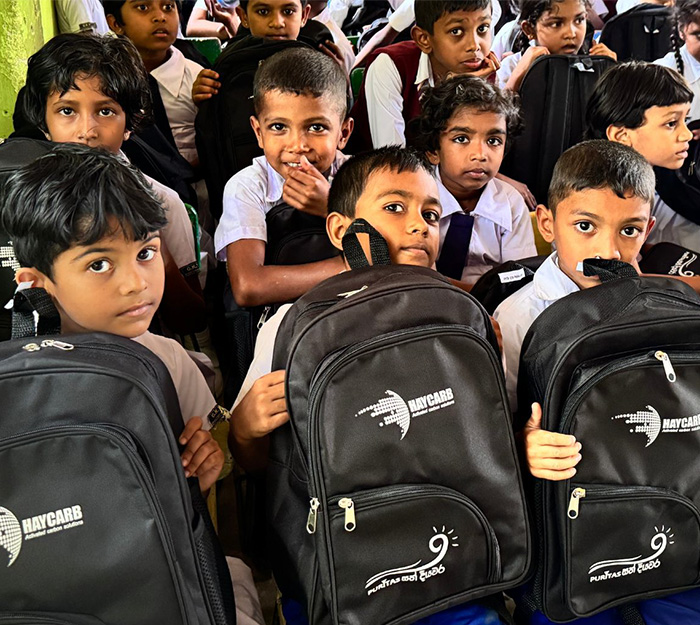 Community members receiving school supplies