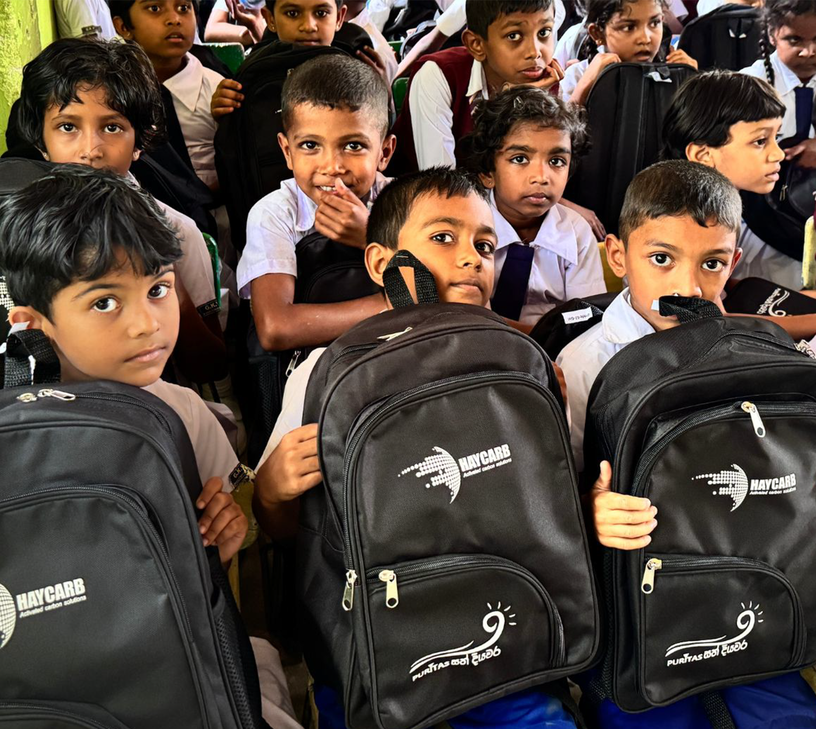 Community members receiving school supplies